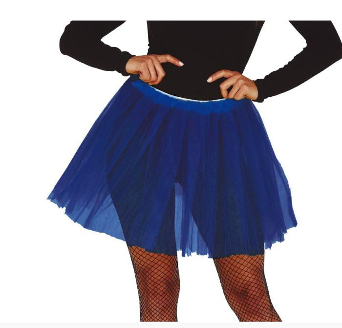 A royal blue tulle tutu skirt worn by a model, paired with a black long-sleeve top and fishnet stockings, shown against a plain white background.