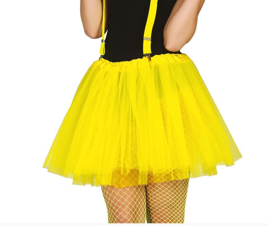 A bright yellow tulle tutu skirt with matching yellow suspenders, shown on a model from the back against a white background.