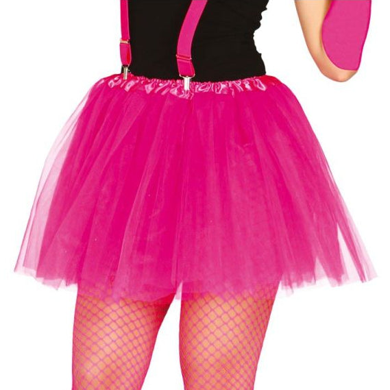Person wearing a bright pink tutu skirt with suspenders on a white background