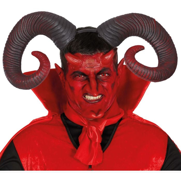 Person wearing a red devil costume with horns on a white background