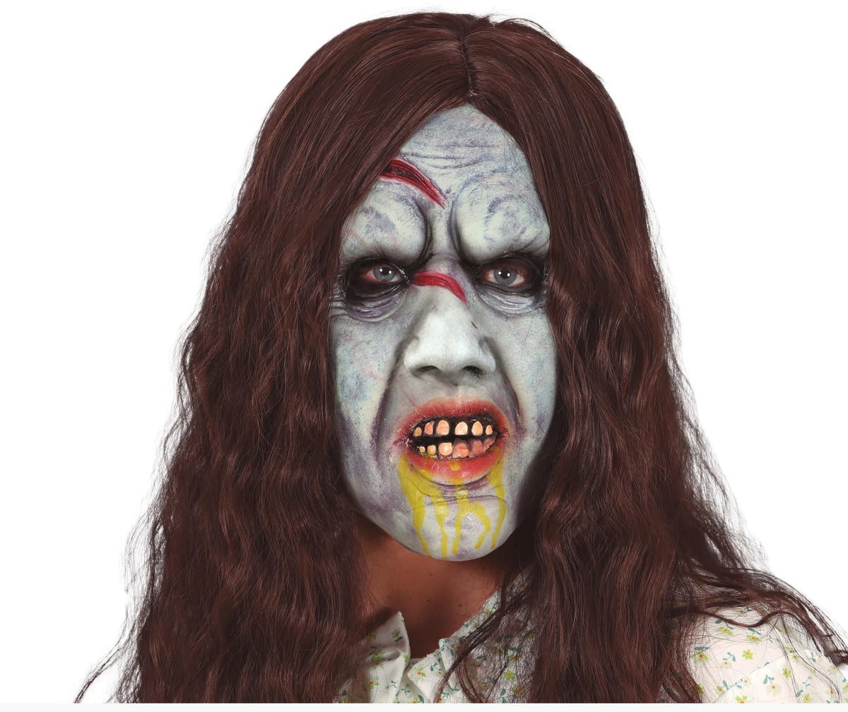 Halloween mask with zombie-like face and long brown hair on a white background