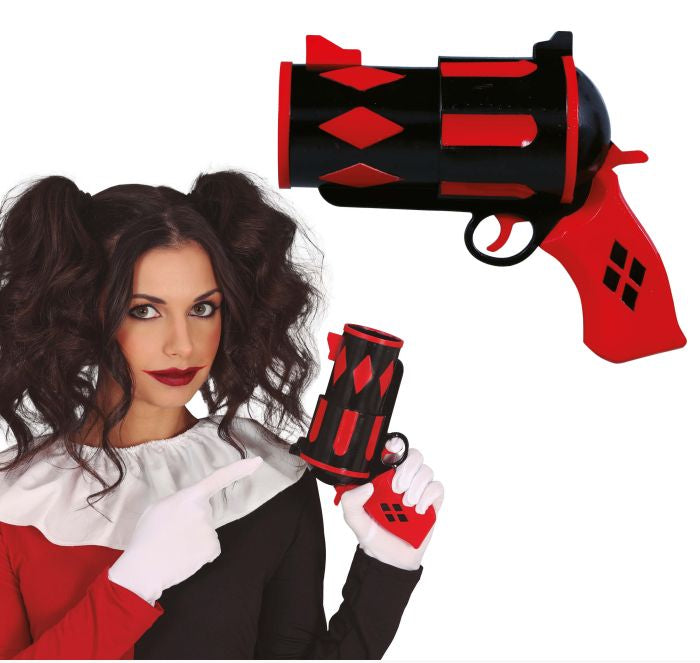 Person in costume holding a red and black gun prop with Fiestas Guirca branding.