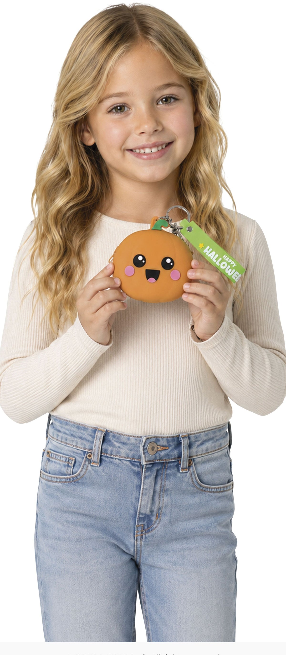 A young girl with long blonde hair smiles while holding a small orange plush character toy with a green 'WELCOME' tag. She is wearing a cream ribbed long-sleeve top and light blue jeans against a plain white background.