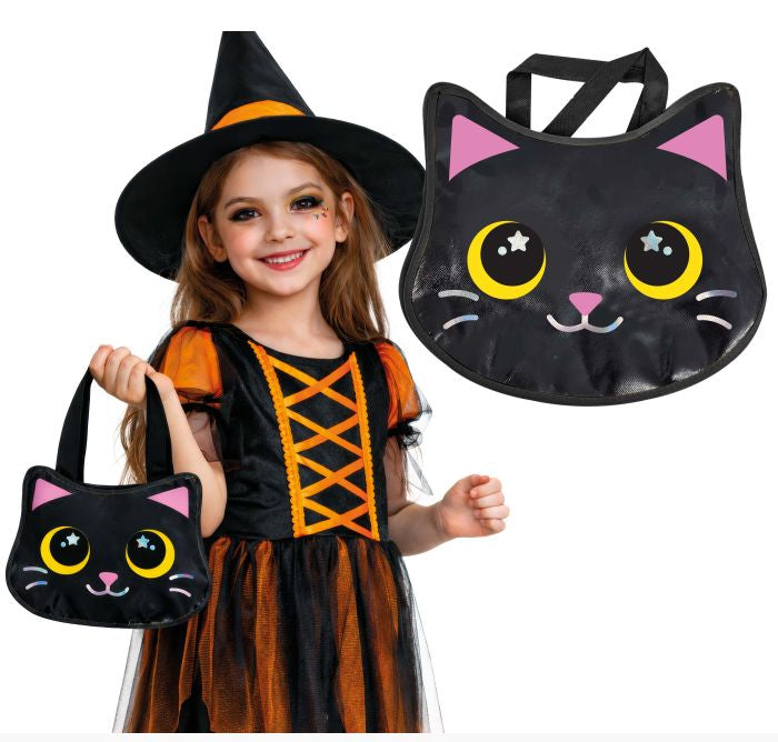 A young girl in a witch costume holds a black cat-shaped Halloween bag with pink ears and yellow eyes, while a larger matching bag is shown beside her on a white background. The product appears to be the cat-shaped handbag/costume accessory rather than the child herself.