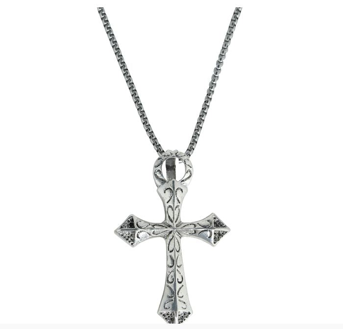 A silver-toned cross pendant necklace with ornate engraved details, hanging from a matching box chain against a plain white background.