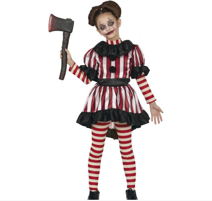 A child modeling a scary clown costume with red and white vertical stripes, black ruffles, and striped tights, holding a toy axe against a plain white background.