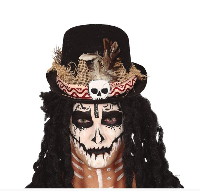 A person wearing a black top hat decorated with burlap, feathers, a small white skull, and a red-and-white chevron band, with Day of the Dead style face paint and long black dreadlocks on a white background.