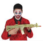 A man with clown face makeup wearing a red patterned jacket, holding a gold-colored toy rifle against a white background.