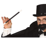 A man dressed as a magician in a black top hat, glasses, fake beard, and black tuxedo jacket holds up a black-and-white magic wand against a plain white background. A copyright notice for Fiestas Guirca s.