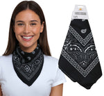 Woman wearing a black bandana with white patterns, next to a package of black bandana socks.