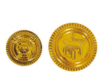 Two round gold foil coins or medallions shown on a white background, one displaying a skull with crossed tools and the other showing a festive building with the number 10. A copyright notice for Fiestas Guirca s.