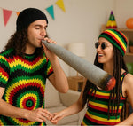 Two people in colorful Rastafarian-themed clothing holding a large fake joint.