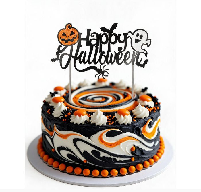 A round Halloween cake decorated with black, white, and orange swirls, piped white frosting dollops, and orange candy-like beads around the base, topped with a black 'Happy Halloween' script topper featuring a jack-o'-lantern, bats, and a ghost.