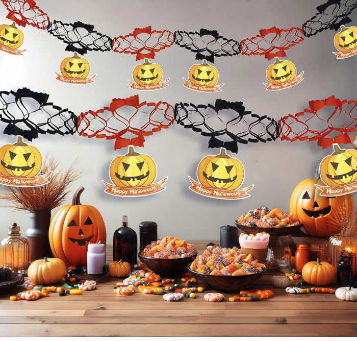 Halloween-themed decorations with pumpkins and garlands on a table.