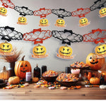 Halloween-themed decorations with pumpkins and garlands on a table.