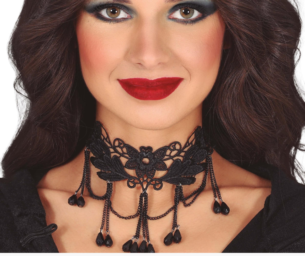 Woman wearing a black lace choker necklace with red lipstick on a white background