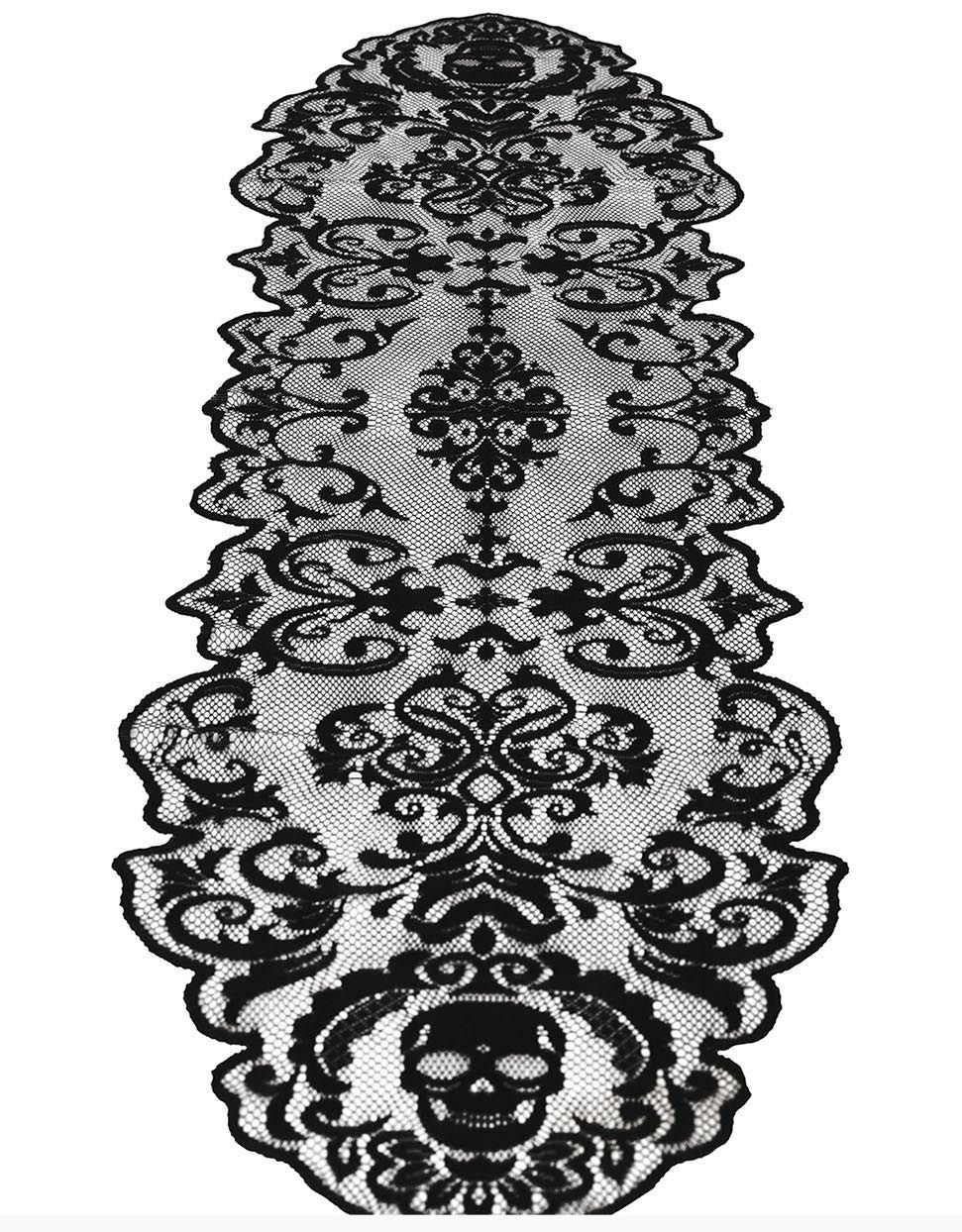 Black lace table runner with an ornate baroque damask pattern and a skull motif at the bottom, shown on a white background.