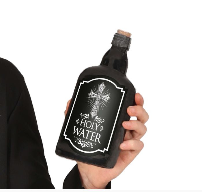 Hand holding a black bottle labeled 'Holy Water' with a cross design on a white background.