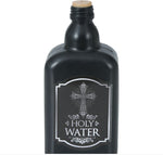 A black bottle-shaped Holy Water container with a cork stopper, featuring a silver label with a cross and the words 'HOLY WATER'.