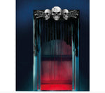A gothic Halloween curtain decoration featuring three skulls and crossed bones at the top, with black dripping fabric hanging down clear plastic panels illuminated by blue and red lights. The image is branded with 'FIESTAS GUIRCA s.