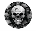 A circular black and white graphic featuring a detailed skull centered over a background of dark skulls and smoke. 