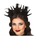 A gothic-style black fascinator headpiece with spikes, fabric flowers, and feathers, shown worn on a model's head against a white background.