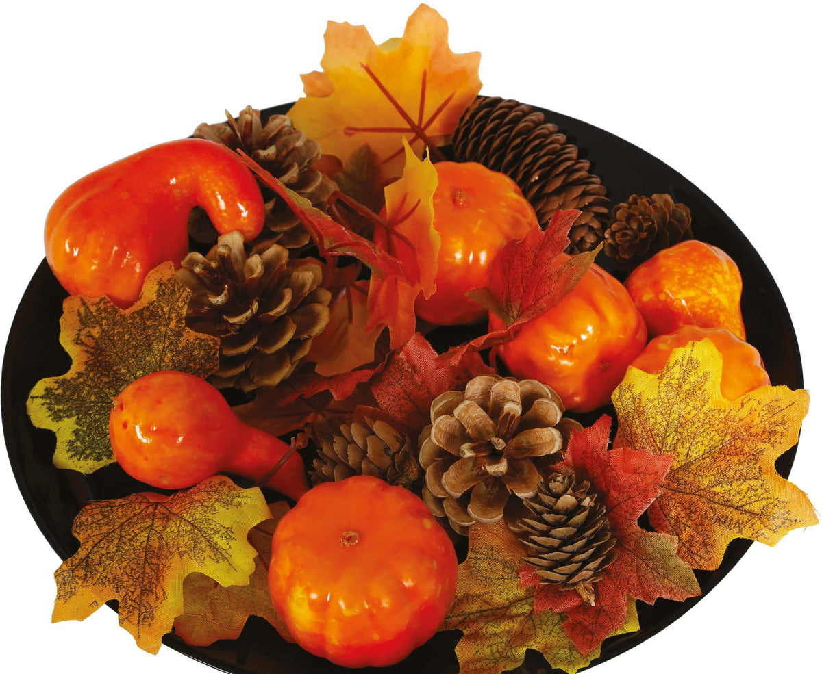 Decorative arrangement with pumpkins, pinecones, and leaves on a black background