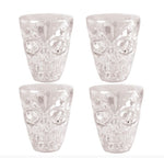 Four clear skull-shaped drinking glasses arranged in a 2x2 grid on a white background, with a copyright notice for Fiestas Guirca s.j.