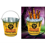 A novelty metal bucket with a handle, printed with a yellow biohazard label reading 'BIOHAZARD INFECTED DRINK.' The left panel shows the bucket alone on a white background; the right panel shows it filled with ice and brown bottles in a spooky purple forest scene.