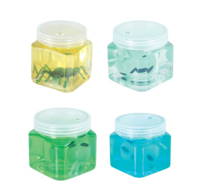 Four small translucent plastic jars with screw-top lids, arranged in a 2x2 grid on a white background. Each jar contains a different colored liquid or gel: yellow, pale aqua, green, and blue, with small dark spider-like figures inside.