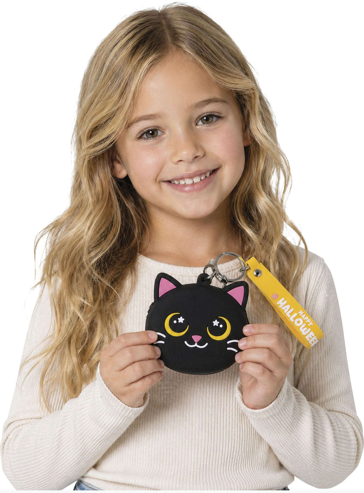 A young girl with long blonde hair holds a small black cat-shaped coin purse with a yellow keychain tag. The purse has pink ears, yellow eyes, and a white nose.