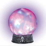 A decorative crystal ball with a pink and blue marbled pattern, resting on an ornate dark metal base with a skull detail, set against a white background with a purple glow.