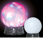 Two decorative crystal ball lamps on ornate silver bases against a black background. The larger left ball glows with pink, purple, and blue marbled light, while the smaller right ball is solid white.