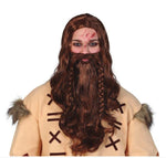 A model wearing a Viking costume wig with long brown hair, a matching beard, and a tan tunic with faux fur trim, against a plain white background.