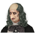 Person wearing a half-wig with gray hair and a bald patch, black shirt, and polka dot bow tie.