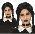 Person wearing a black and white costume with braided hair, branded 'Fiestas Guirca'.