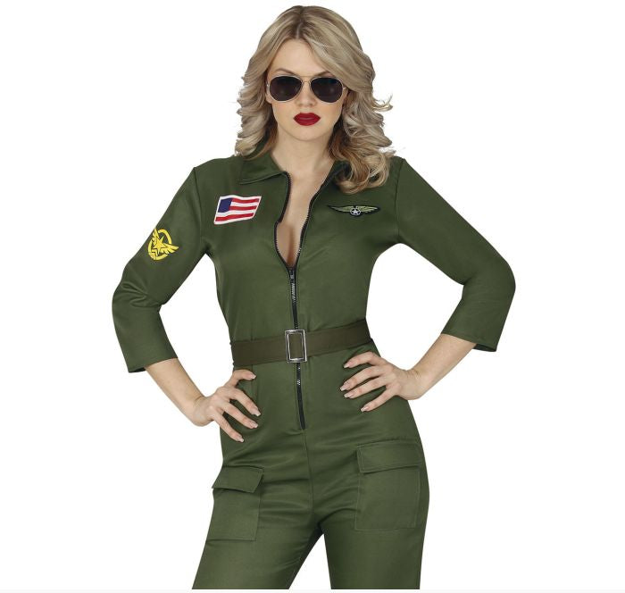 A woman modeling an olive green military-style jumpsuit costume with a front zipper, belt, sleeve patches, and a chest insignia, photographed against a plain white background.