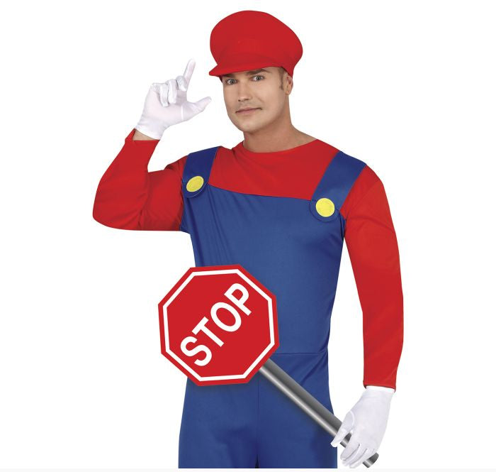 A man modeling a Mario-inspired costume with a red cap, red long-sleeve shirt, blue overalls, white gloves, and holding a stop sign prop against a plain white background.