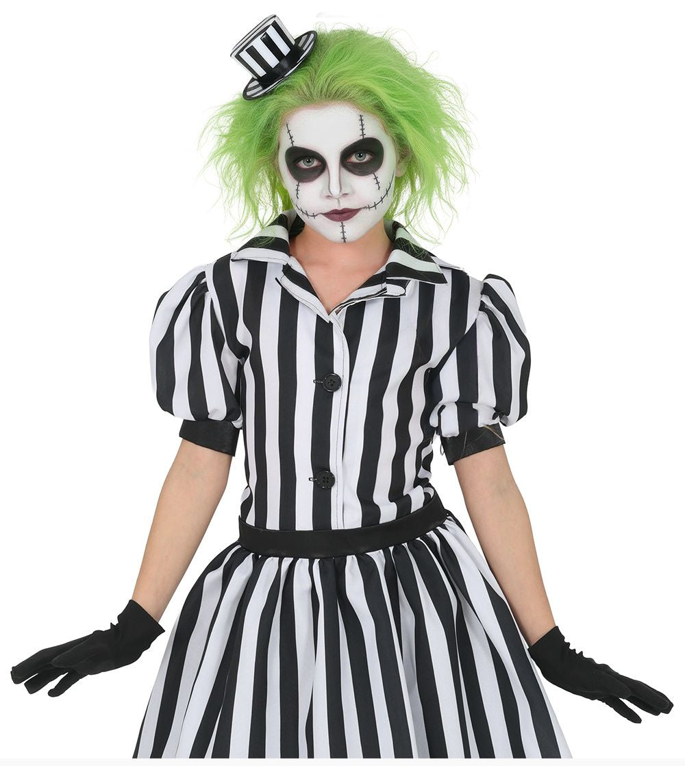 A person modeling a black and white striped costume dress with black gloves, bright green wig, and a small black-and-white top hat against a plain white background.