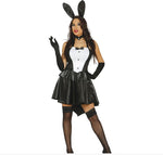 A woman modeling a black and white bunny costume with black faux-leather skirt, matching black gloves, thigh-high stockings, a black choker, and black bunny ears on a white background.