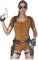 A woman modeling a brown short-sleeve zip-front bodysuit with black harness-style shoulder straps, a black waist belt with silver buckle, black fingerless gloves, and black thigh straps, holding a silver pistol prop against a white background. 