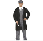 A man modeling a vintage-style costume consisting of a long black coat over a gray three-piece suit, white shirt, black tie, and gray flat cap, holding a silver knife prop against a white background.