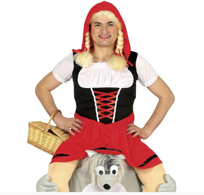 A man wearing a Red Riding Hood costume, sitting on a gray plush wolf toy and holding a wicker basket, against a white background.