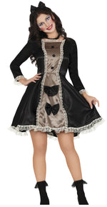 Woman wearing a black and brown dress with a bow detail on a white background