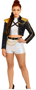 Woman wearing a sparkling black and gold jacket with white shorts on a white background