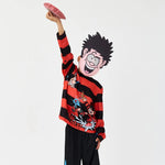 Person wearing a red and black striped sweater with cartoon character design, holding a phone.